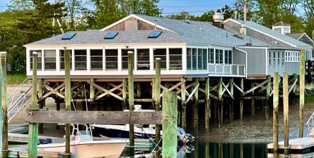 Photo of restaurant exterior as seen from across the harbor