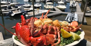 Lobster dinner with boats in the harbor
